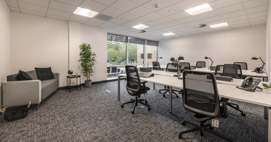 Open-plan office with desks, chairs and freshly cleaned carpet