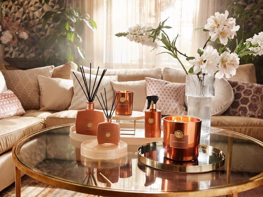 Living room styled with copper diffusers, candles and fresh flowers