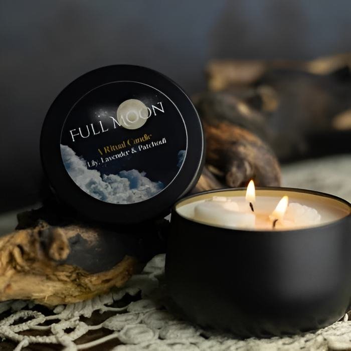 Lit Full Moon ritual candle beside driftwood on a lace runner